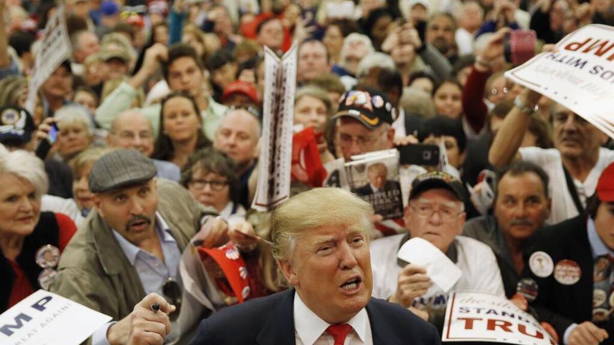 Republican presidential candidate Donald Trump speaks speaks with members of the media as he meets with attendees during a campaign stop on Friday, Feb. 19, 2016, in Myrtle Beach, S.C.