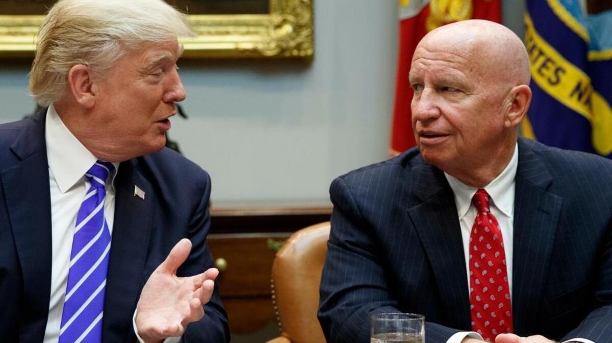 Rep. Kevin Brady, R-Texas, right, listens as President Donald Trump speaks during a meeting with members of the House Ways and Means committee in the Roosevelt Room of the White House, Tuesday, Sept. 26, 2017, in Washington.