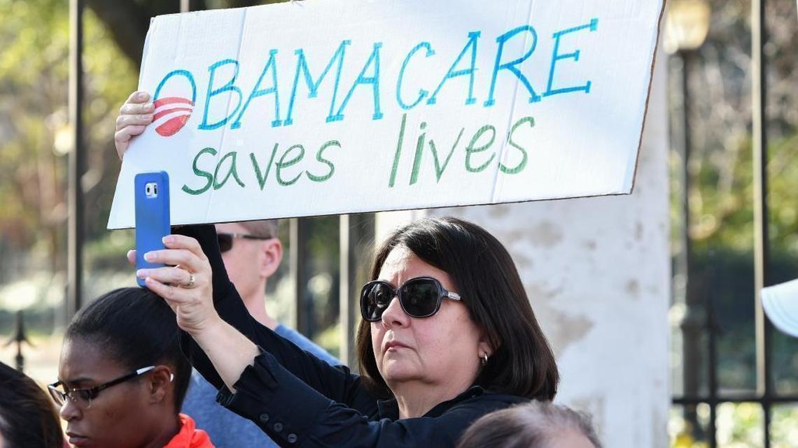 Affordable Care Act supporter Lucero Mesa holds a sign during an ACA support rally at the South Carolina Governor's Mansion.