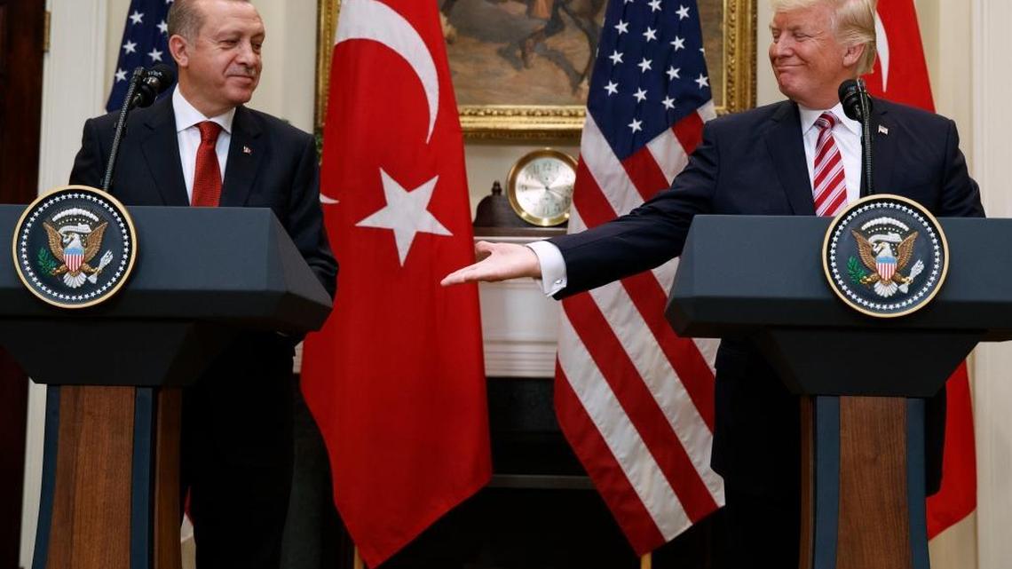 President Donald Trump reaches out to shake hands with Turkish President Recep Tayyip Erdogan in the Roosevelt Room of the White House, Tuesday, May 16, 2017, in Washington.
