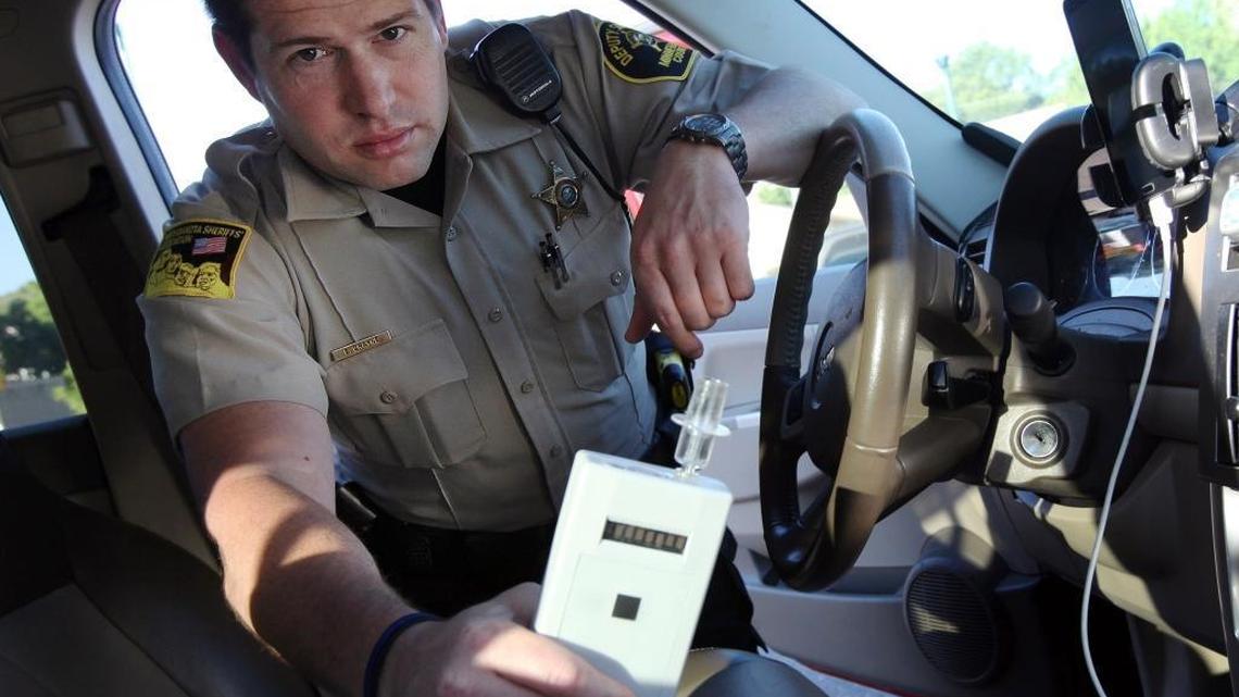 Minnehaha County Deputy Sheriff Elliott Crayne shows off a breathlyzer in his patrol vehicle.