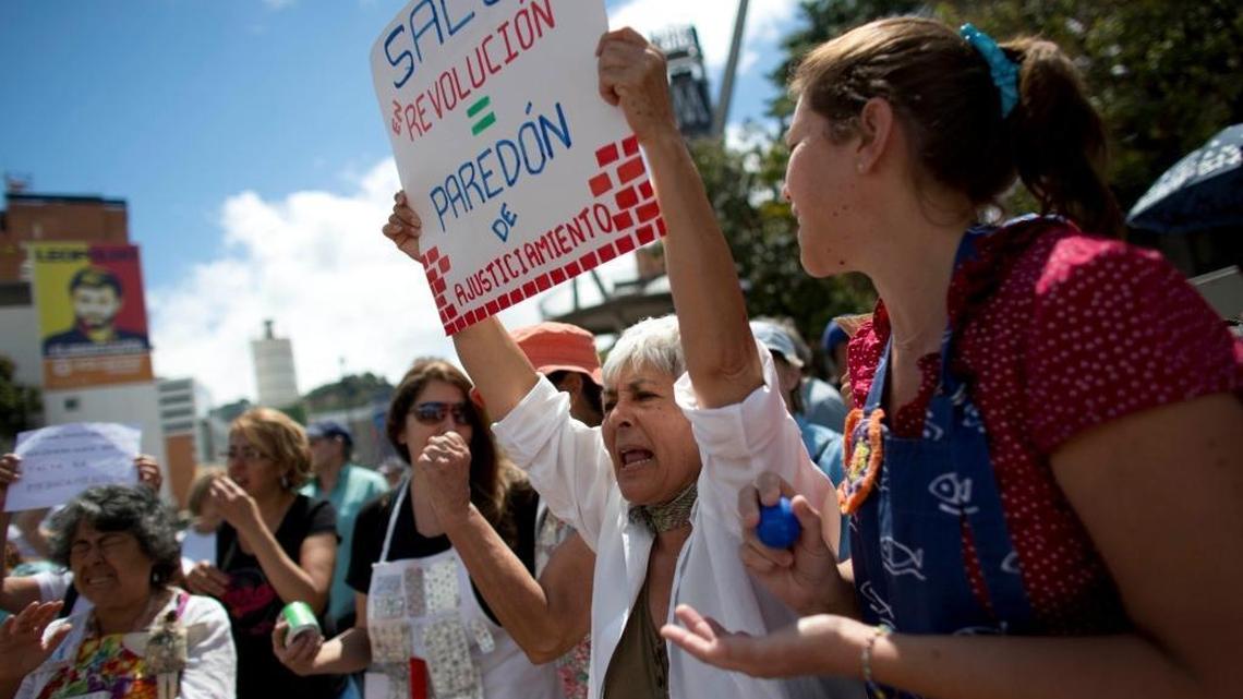 People take part in a protest demanding the government attend to the country's health crisis, in Caracas, Venezuela, Thursday, Feb. 8, 2018. Shortages of medicine, medical supplies and services are causing avoidable deaths in the South American country.