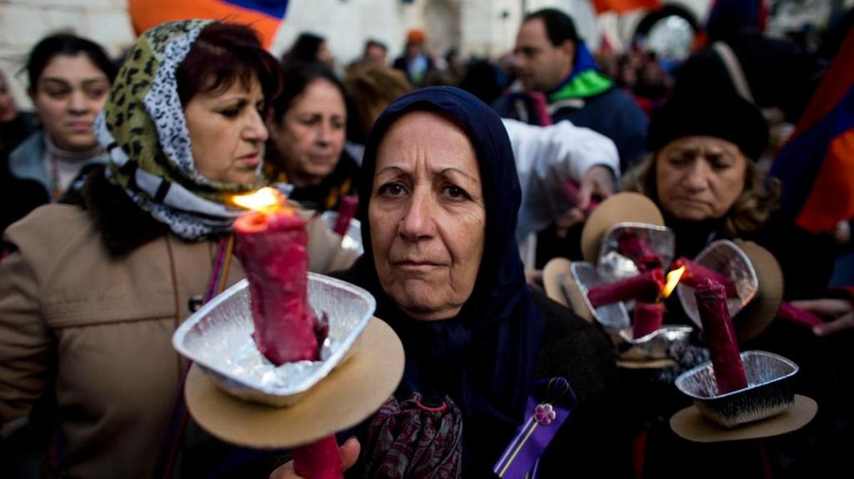 Armenian women hold torches to commemorate the 100th anniversary of what many call the first genocide of the 20th century last year in Jerusalem.