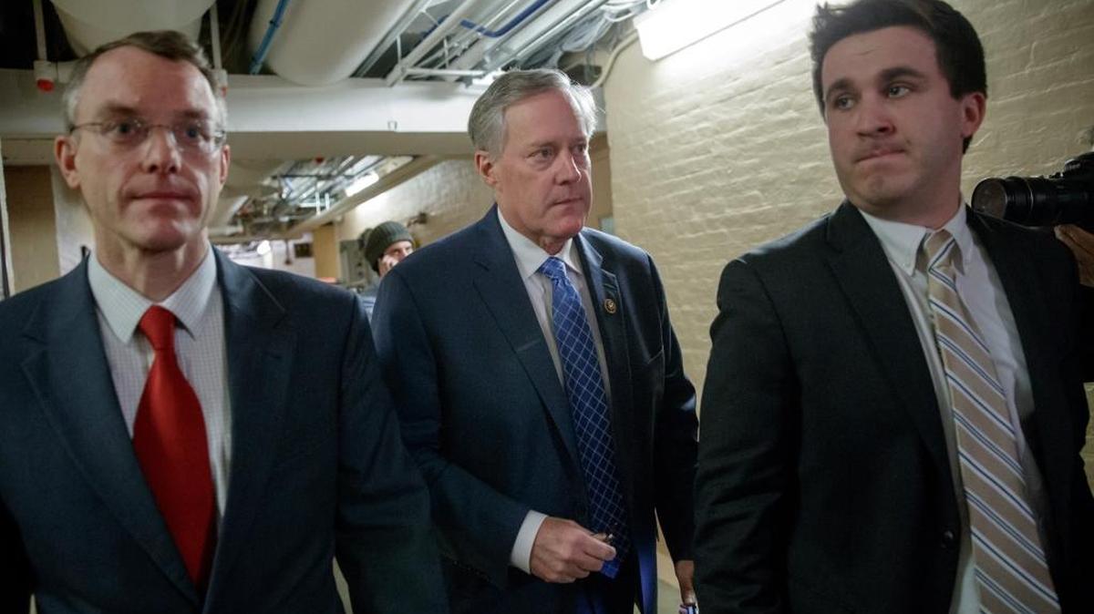 House Freedom Caucus Chairman Rep. Mark Meadows, R-N.C., center, rushes to a caucus in the basement of the Capitol in Washington, Friday, March 24, 2017, before House Speaker Paul Ryan of Wis. announced that he is abruptly pulling their troubled health care bill off the House floor.