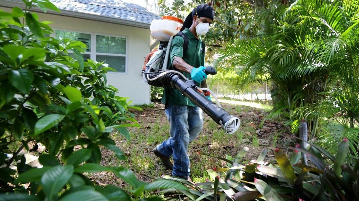 A spray technician with Pinellas County Mosquito Control uses a fogger to distribute VectoBac, a biopesticide engineered to kill mosquito larvae, into plants behind a home in Oldsmar, Fla., on Aug. 23, 2016. Efforts in Congress to reach a bipartisan deal on funding to fight Zika failed earlier this summer.