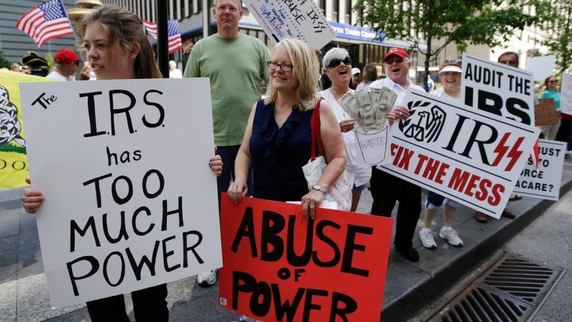 In this May 21, 2013, photo, tea party activists demonstrate on Fountain Square before marching to the John Weld Peck Federal Building in Cincinnati to protest the Internal Revenue Service's alleged targeting of conservative groups seeking tax-exempt status. Tea party activists are heartened by a federal appeals court ruling that strengthens their legal push against the IRS for alleged targeting in past election cycles. A Cincinnati-based panel chastised government foot-dragging while ordering the agency to give attorneys for tea party groups details on tax-exempt applicants.