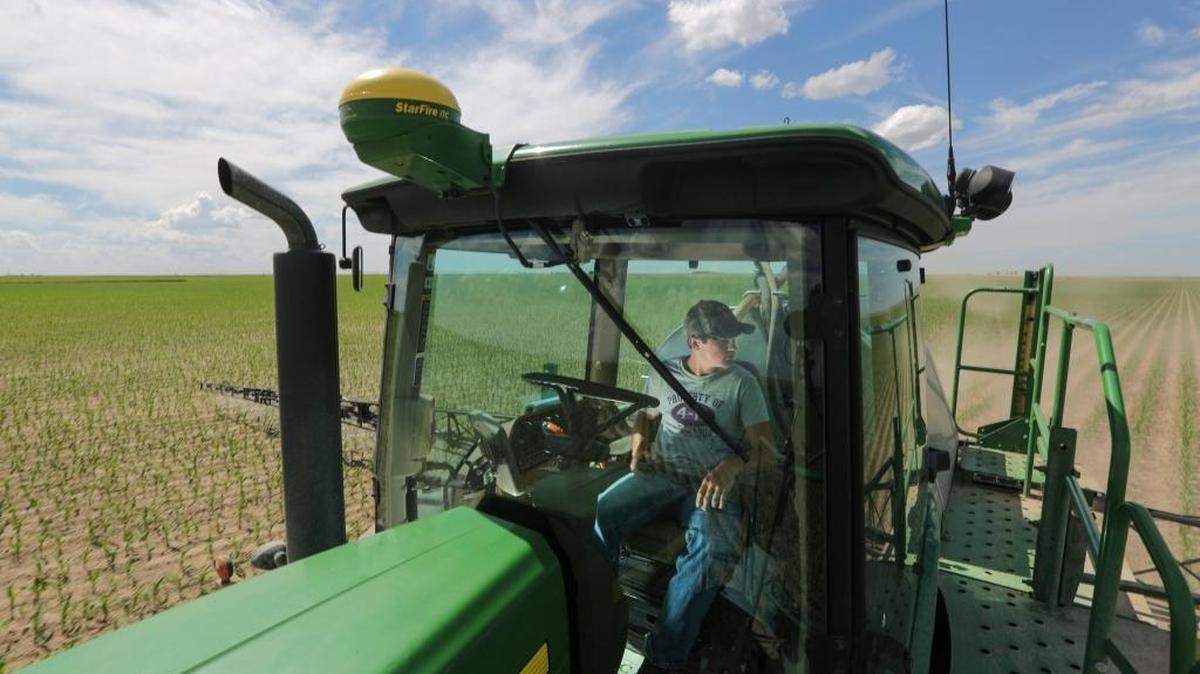 Braden Scott drives a crop sprayer over an irrigated cornfield near Ulysses, Kan., on June 9, 2015. Farmers in Kansas and other rural states would see a 36 percent cut to crop insurance under President Donald Trump’s budget proposal.