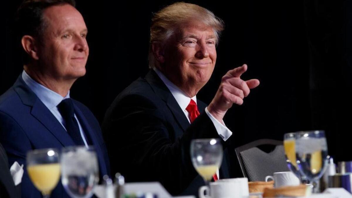 President Donald Trump, accompanied by television producer Mark Burnett, points to the crowd during the National Prayer Breakfast, Thursday, Feb. 2, 2017, in Washington.