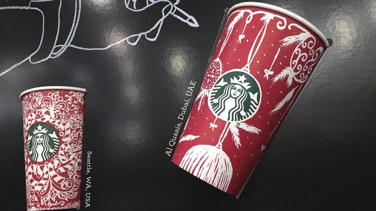 In this Tuesday, Nov. 8, 2016, photo, Starbucks holiday cups appear on display at a store in New York. Snowflakes, reindeer and candy canes are back on Starbucks holiday coffee cups, after last year’s plain red cups caused uproar from critics who said the chain was part of a so-called war on Christmas.