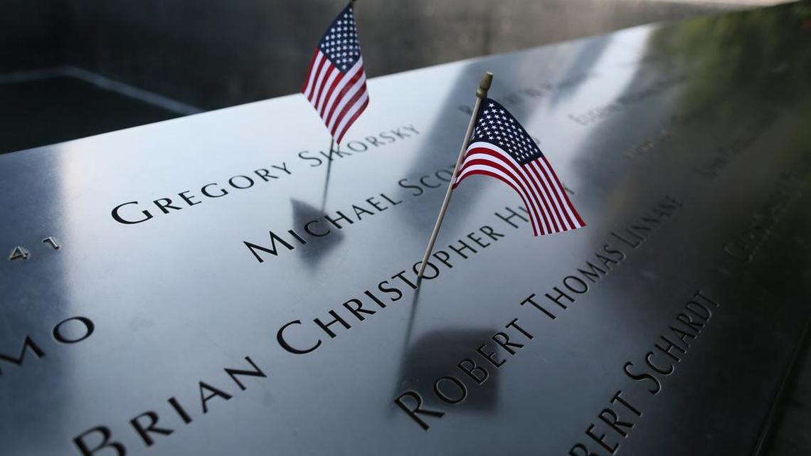 American flags are placed on the south pool of the National September 11 Memorial Saturday in New York. Sunday marks the 15th anniversary of the attacks on the World Trade Center.