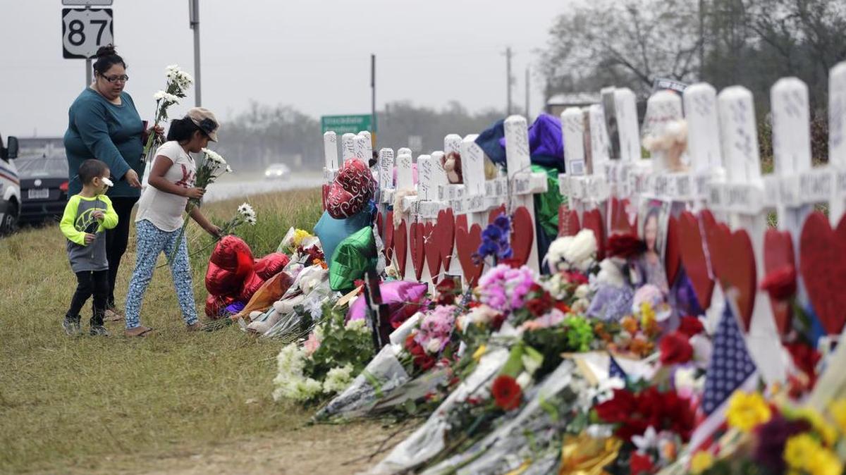 A family visits a makeshift memorial for the victims of the shooting at Sutherland Springs Baptist Church, Sunday, Nov. 12, 2017, in Sutherland Springs, Texas. Pastor Frank Pomeroy, whose 14-year-old daughter, Annabelle, was among the 26 killed in the massacre, said Robert Ussery approached him Monday and said, “Your daughter never even existed. Show me her birth certificate. Show me anything to say she was here.”