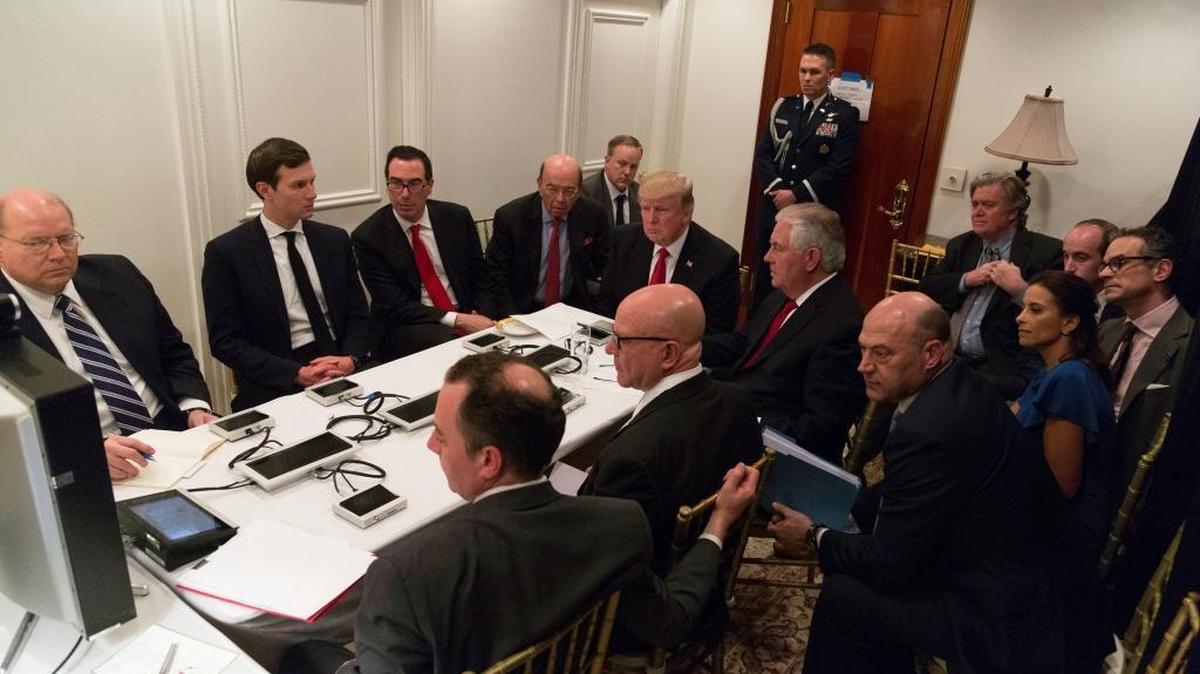 In this image provided by the White House, President Donald Trump receives a briefing on the Syria military strike from his national security team after the strike, at Mar-a-Lago in Palm Beach, Fla., Thursday, April 6, 2017.