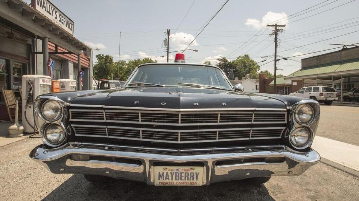 A vintage Ford Galaxie 500, decorated as a Mayberry police car, serves an Andy Griffith-themed tour-mobile of Mount Airy, N.C.