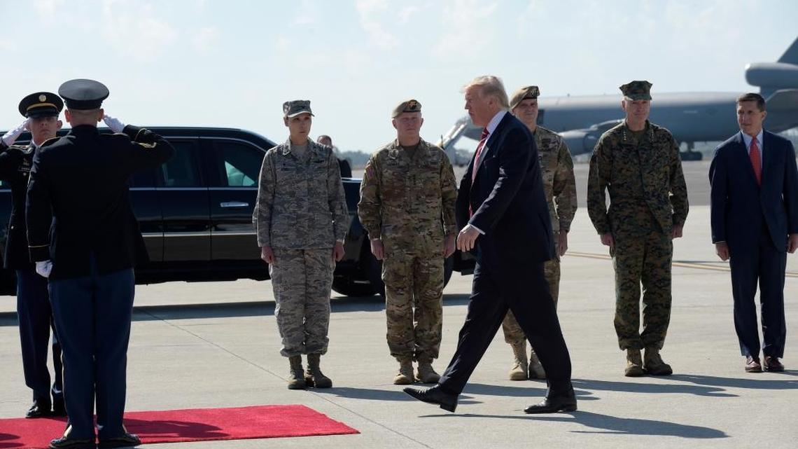 President Donald Trump arrives via Air Force One at MacDill Air Force Base in Tampa, Fla., Monday, Feb. 6, 2017. He stopped for a visit to the headquarters for U.S. Central Command and U.S. Special Operations Command before returning to Washington. National Security Adviser Michael Flynn is at right, and Joint Chiefs Chairman Gen. Joseph Dunford is second from right.