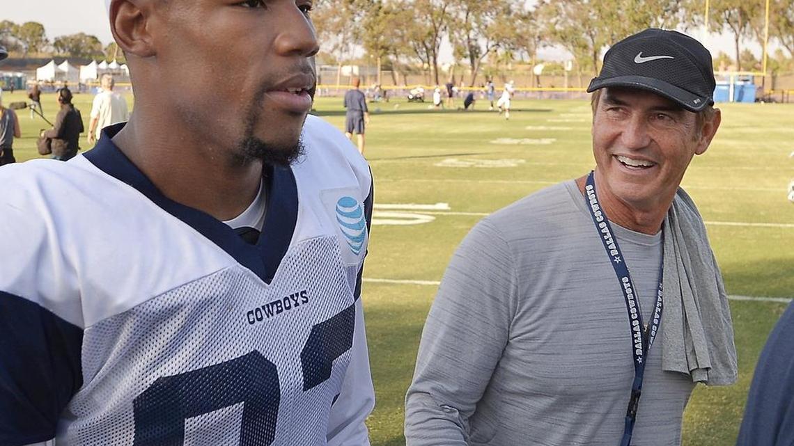 Former Baylor football coach Art Briles is shown walking off the field with Dallas Cowboys wide receiver Terrance Williams after a training camp practice in Oxnard, Calif.