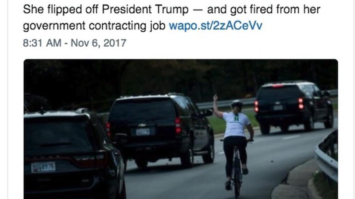 Juli Briskman gives the middle finger to President Donald Trump’s motorcade as it passes her in Sterling, Virginia.