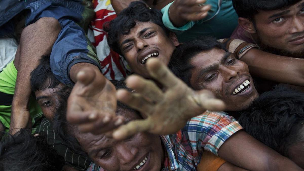 Rohingya Muslims stretch out their arms to reach food being distributed near Balukhali refugee camp in Cox's Bazar, Bangladesh, Wednesday, Sept. 20, 2017. With Rohingya refugees still flooding across the border from Myanmar, those packed into camps and makeshift settlements in Bangladesh are desperate for scant basic resources and fights erupt over food and water.
