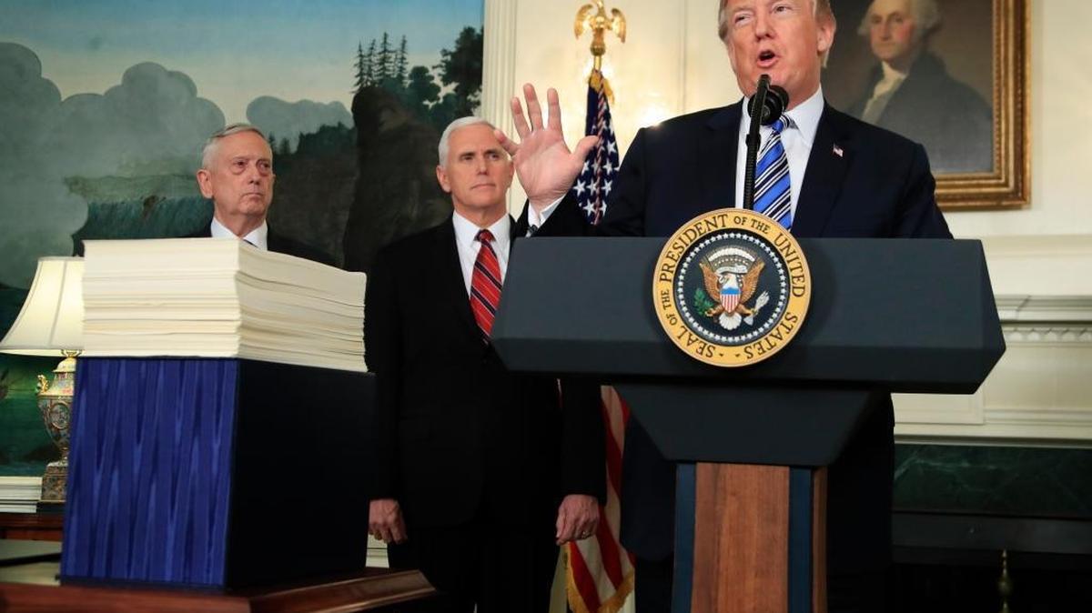 President Donald Trump with, Defense Secretary Jim Mattis, left, and Vice President Mike Pence, speaks in the Diplomatic Room of the White House in Washington, Friday, March 23, 2018, about the $1.3 trillion spending bill.