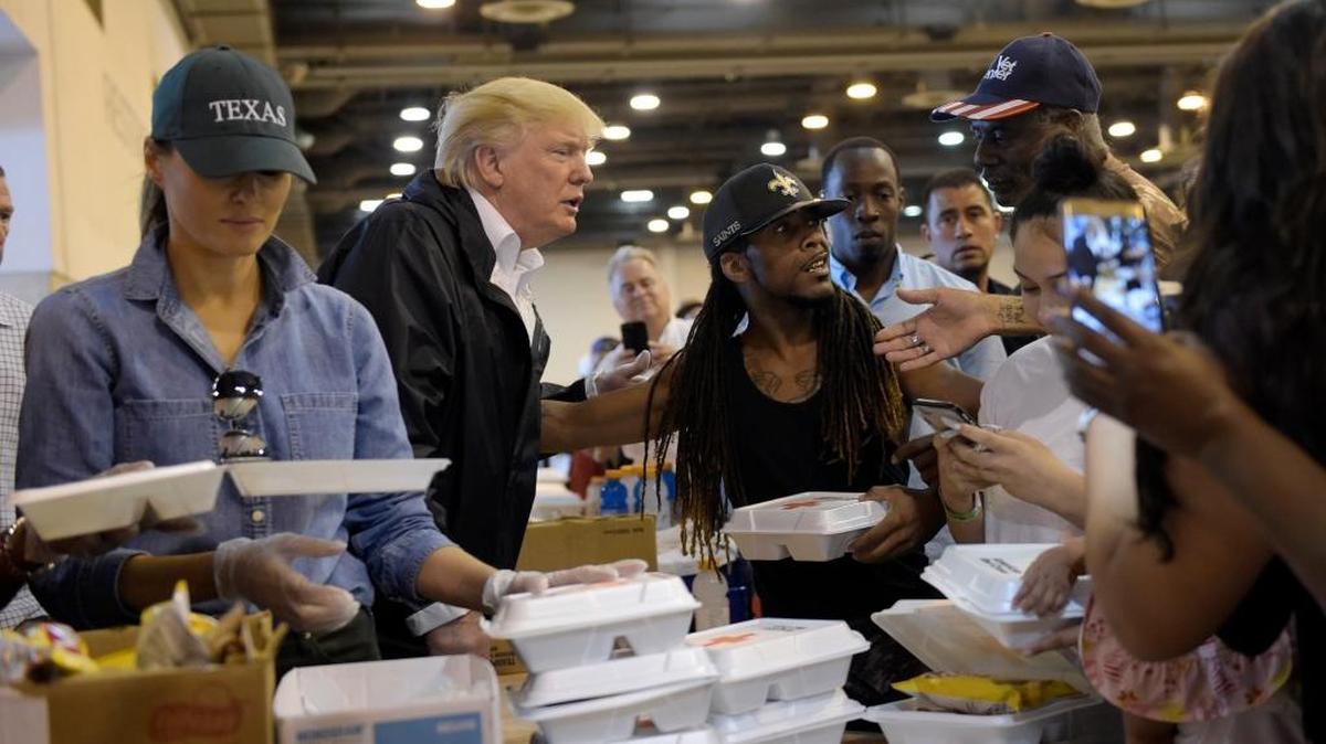 President Donald Trump and Melania Trump pass out food and meet people impacted by Hurricane Harvey during a visit to the NRG Center in Houston Saturday. It was his second trip to Texas in a week, and this time his first order of business was to meet with those affected by the record-setting rainfall and flooding.