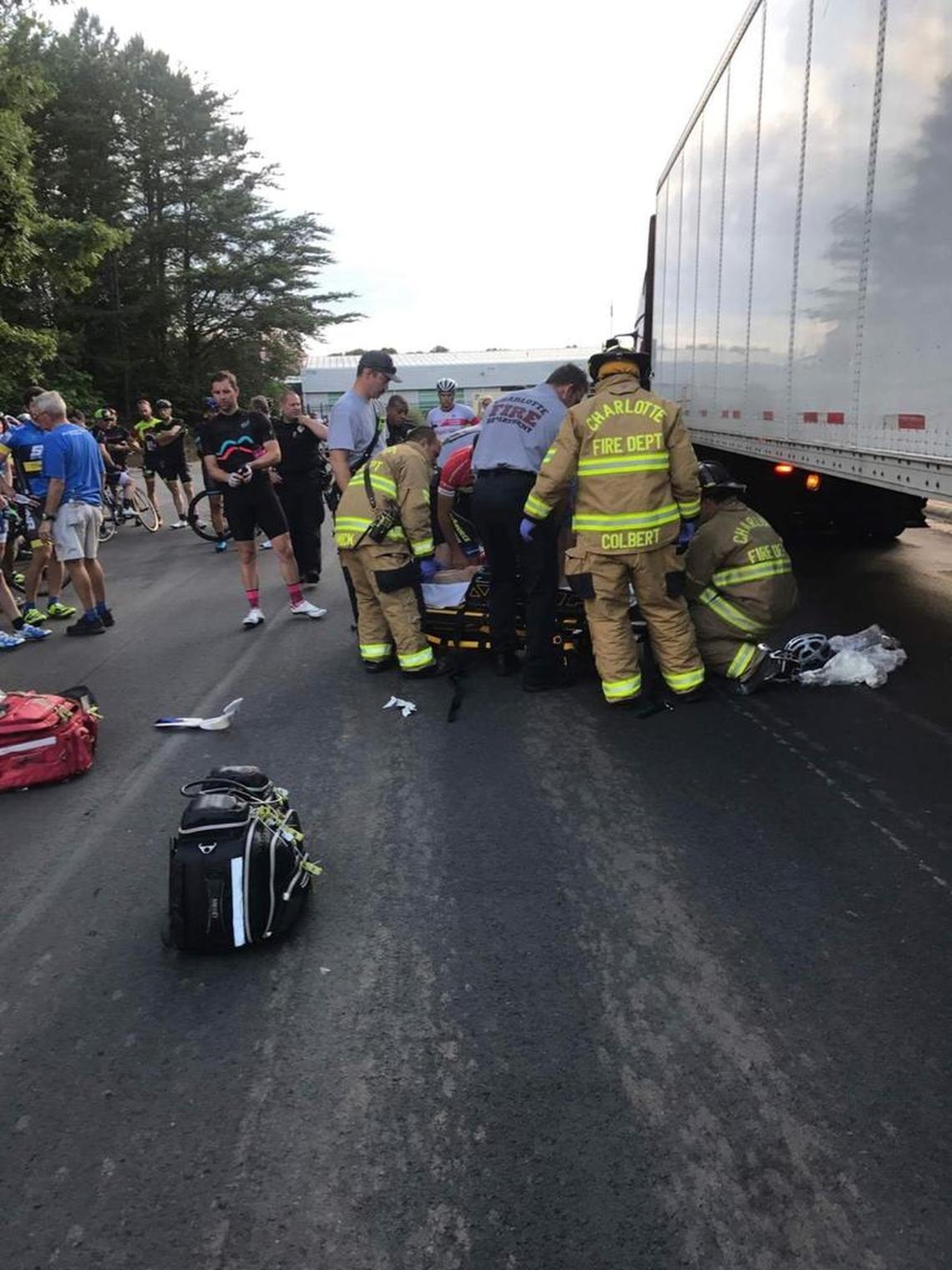 First responders tend to Mark Hoffman after he crashed into a tractor-trailer during a group cycling ride in northeast Charlotte on May 30.