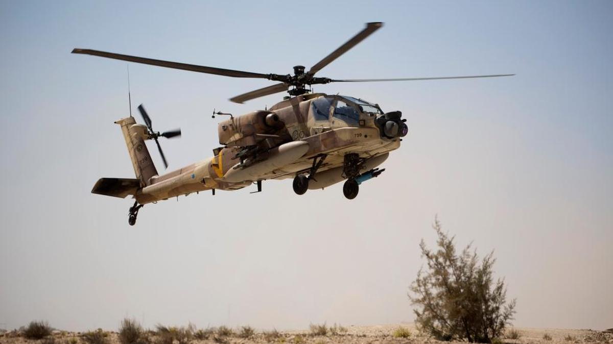 An Israeli Air Force Boeing AH-64 Apache attack helicopter from the 113th Squadron, also known as the Hornet Squadron, lands during a display for the foreign press in Ramon air force base near the Israeli town of Mitzpe Ramon, in the Negev desert, southern Israel, Monday, Oct. 21, 2013.
