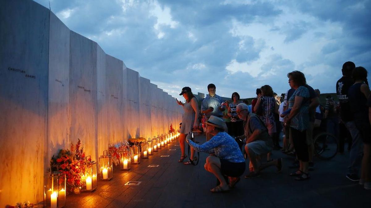 Candles in memory of the passengers and crew of Flight 93 are lit along the Wall of Names at the Flight 93 National Memorial in Shanksville, Pa., Saturday as the nation marks the 15th anniversary of the Sept. 11 attacks.