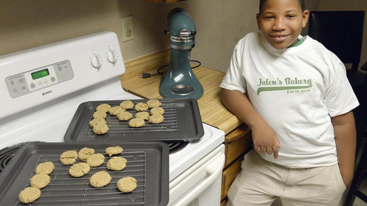Jalen Bailey, 8, of Fresno, Calif., stands next to a fresh batch of peanut butter cookies he made at his family’s home,