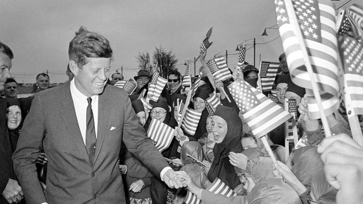 U.S. President John F. Kennedy is greeted by an enthusiastic crowd of children and nuns from the Convent of Mercy, as he arrives from Dublin by helicopter at Galway's sports ground, Ireland, June 29, 1963.