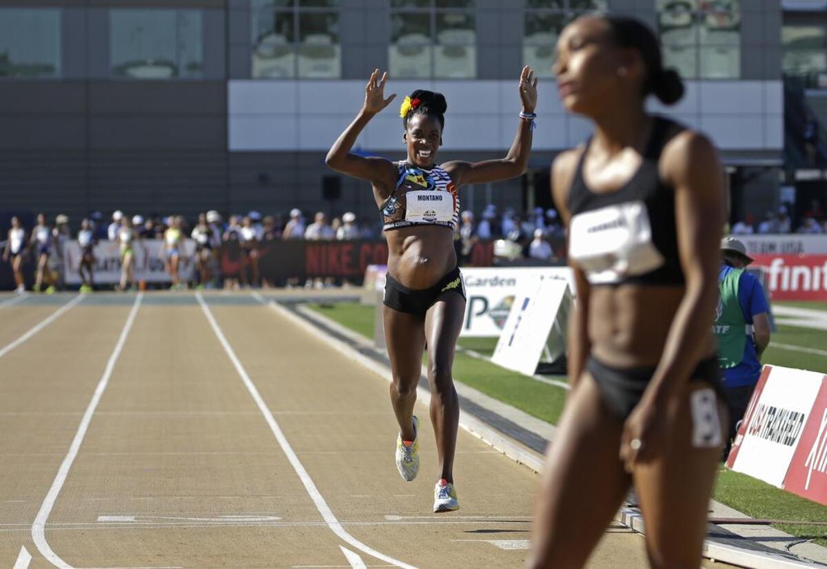 Alysia Montano, left, who is five months pregnant, crosses the finish line during the first round of the women's 800 meters at the U.S. Track and Field Championships, Thursday, June 22, 2017, in Sacramento, Calif.
