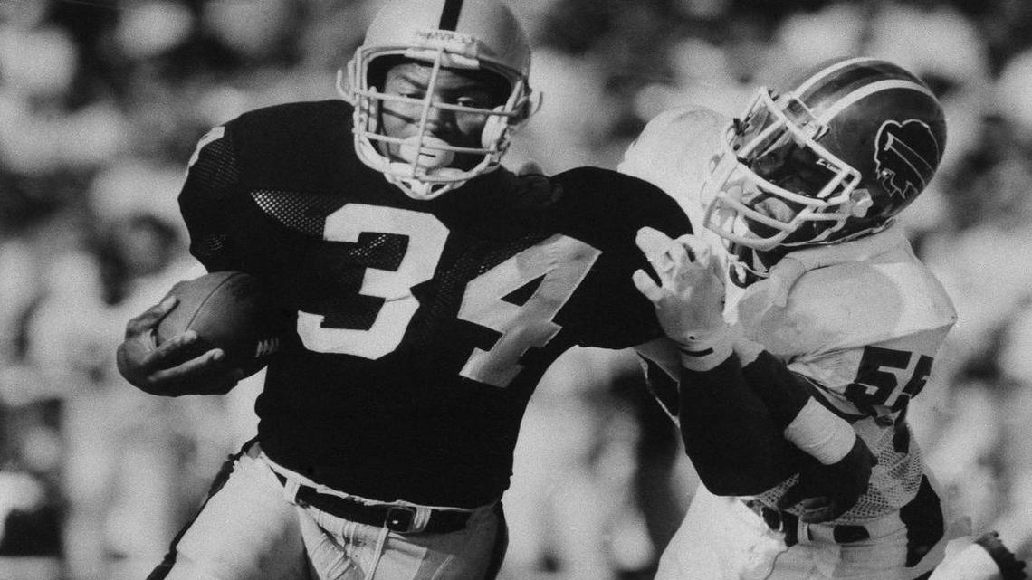 Bo Jackson (34) of the Los Angeles Raiders carries the ball against linebacker Cornelius Bennett (55) of the Buffalo Bills during their game on Sunday, Dec. 6, 1987 at the Coliseum in Los Angeles. Jackson, in his sixth NFL game, accounted for 137 yards in the Raiders 34-21 win over Buffalo.