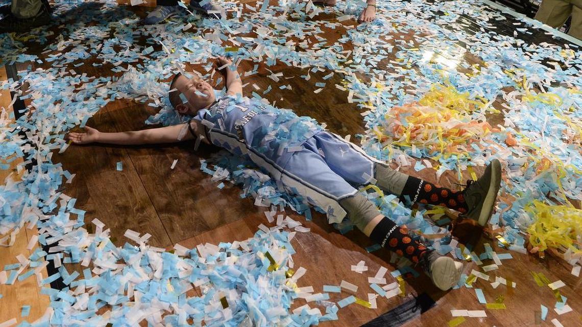 Aiden Williams, the grandson of UNC head coach Roy Williams makes a "confetti angel" on the floor as the Tar Heels celebrate their national championship. UNC beat Gonzaga 71-65 Monday, April 3, 2017 at the NCAA Final Four National Championship game in Glendale, Az. at the University of Phoenix Stadium.