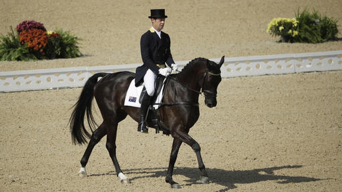 Christopher Burton of Australia rides Santano II in the equestrian eventing dressage competition at the 2016 Summer Olympics in Rio de Janeiro, Brazil, Saturday, Aug. 6, 2016.