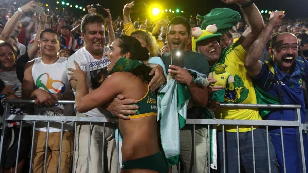 Brazil’s Agatha Bednarczuk, known to fans simply as “Agatha,” celebrates with the crowd after she and her partner beat Team USA on a raucous early Wednesday morning at Copacabana Beach in Rio.