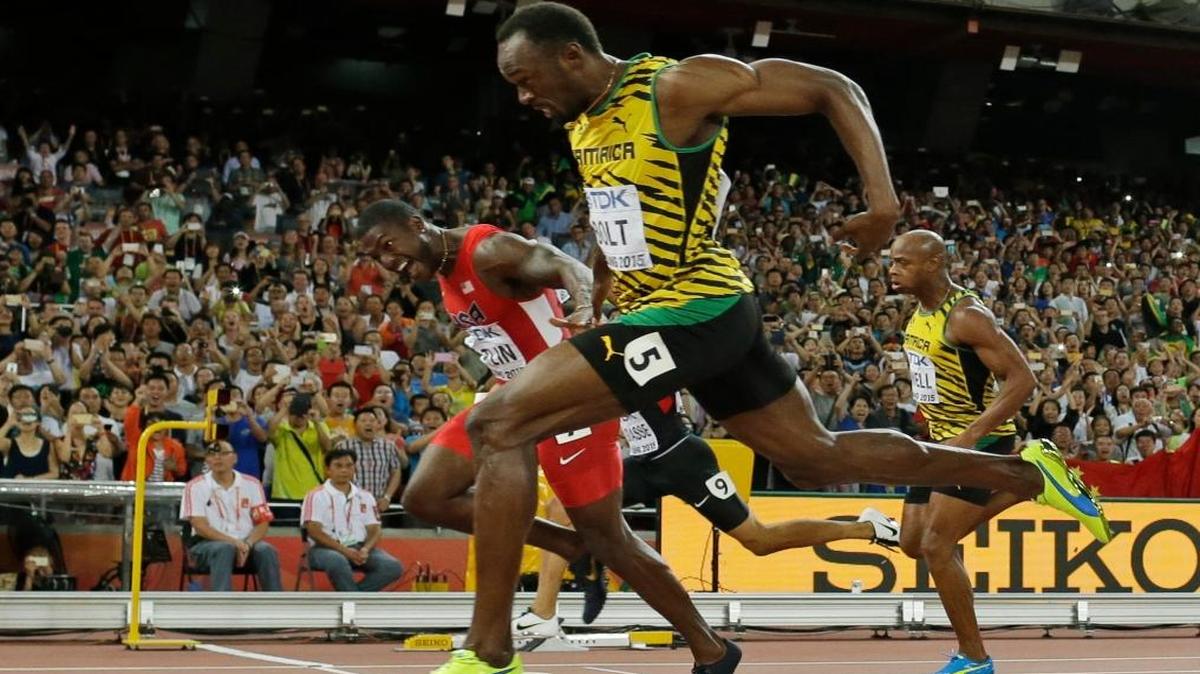 Jamaica's Usain Bolt crosses the finishing in front of United States' Justin Gatlin, left, to win the men’s 100m final at the World Athletics Championships at the Bird's Nest stadium in Beijing, Sun., Aug. 23, 2015.