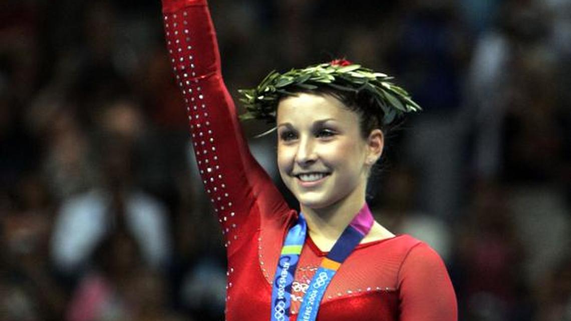 Carly Patterson of the United States holds up her flowers after winning the gold medal in the women’s gymnastics individual all-around competition at the 2004 Summer Olympic Games in Athens on Aug. 19, 2004.