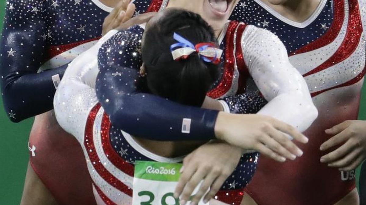 United States gymnast Aly Raisman hugs teammate Simone Biles (391) as Gabby Douglas and Laurie Hernandez look on after winning the gold medal on Tuesday at the end of the women’s team final in Rio de Janeiro.