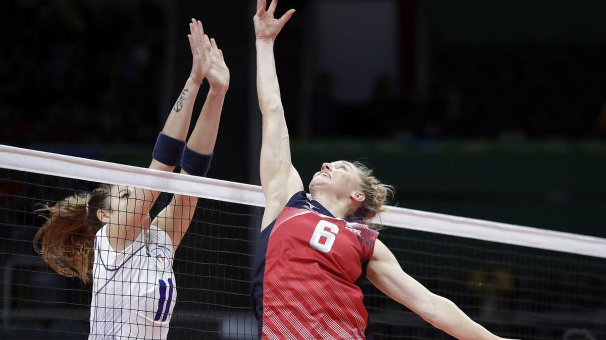 United States’ Carli Lloyd, right, reaches for a ball as Italy’s Cristina Chirichella defends during a women’s preliminary volleyball match at the 2016 Summer Olympics in Rio de Janeiro. Carli Lloyd’s mother had her bag blown up by authorities in Brazil last week.