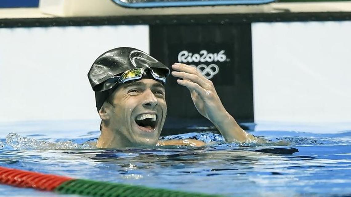 United States swimmer Michael Phelps laughs following the conclusion of the men’s 100-meter butterfly final, in which he was part of a three-way tie for silver on Friday at the Summer Olympics in Rio de Janeiro.