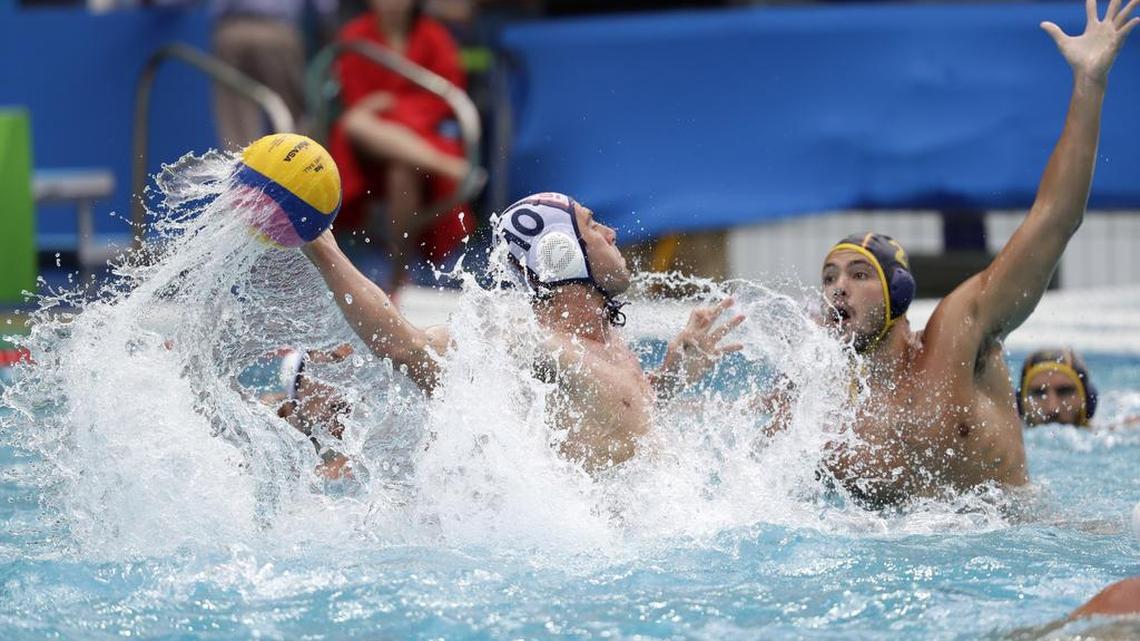 United States' Bret Bonanni, left, takes a shot at goal as Spain's Alberto Munarriz Egana defends during their men's water polo preliminary round match at the 2016 Summer Olympics in Rio de Janeiro, Brazil, Monday, Aug. 8, 2016.