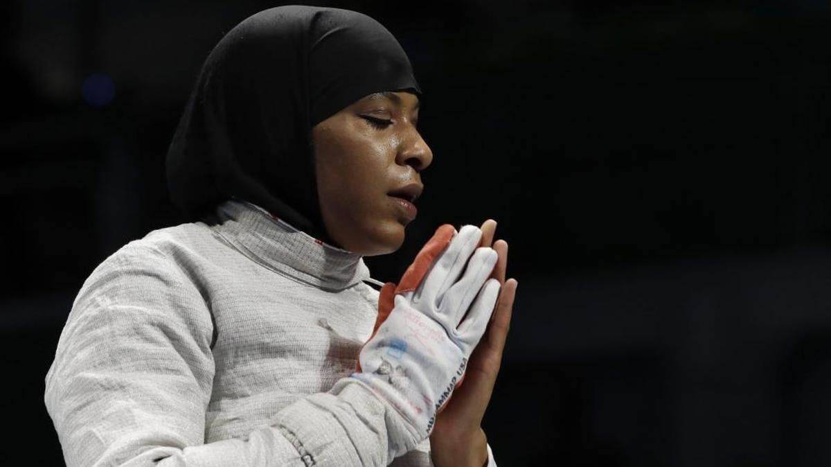 Former Duke fencer Ibtihaj Muhammad, the first American to compete in the Olympics wearing a hijab, reacts after losing against Cecilia Berder of France in the women’s individual saber fencing event on Monday.