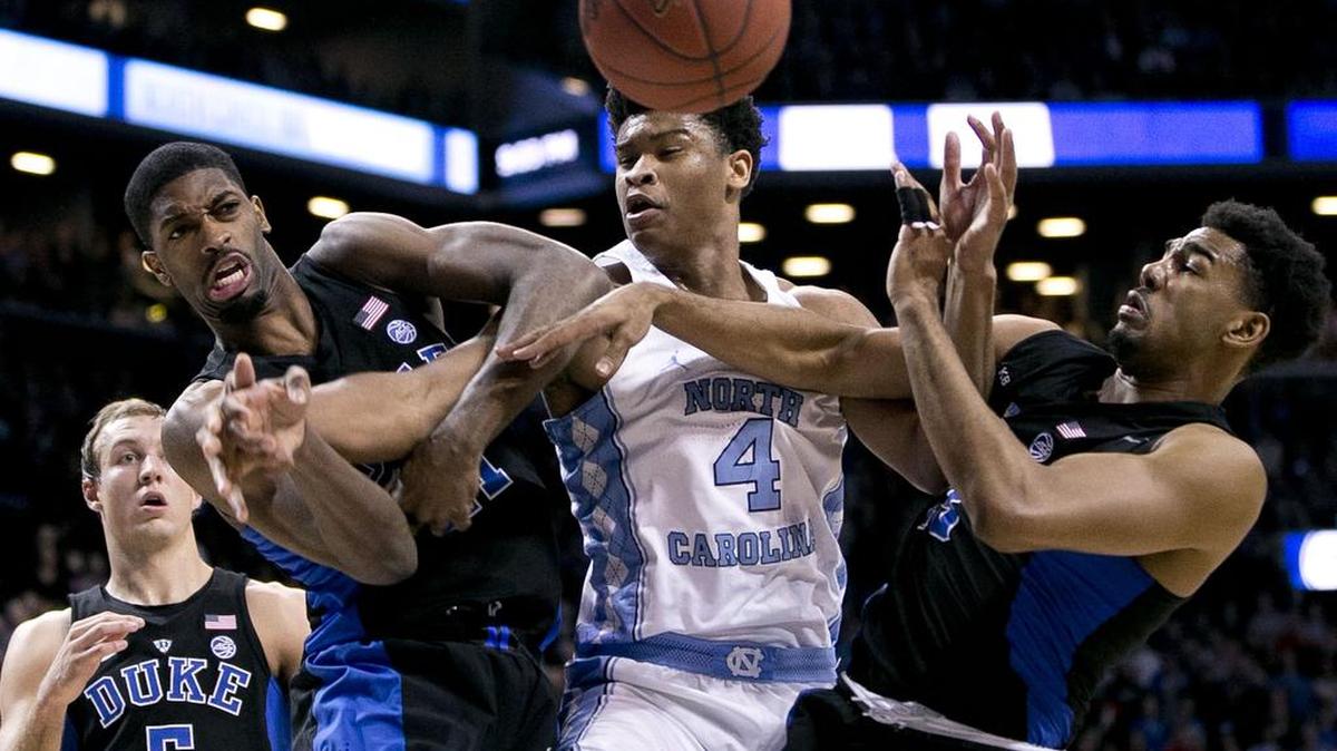 Duke’s Amile Jefferson (21) and Matt Jones (13) defends North Carolina’s Isaiah Hicks (4) in the second half of the ACC Tournament semifinal game against Duke on Friday, March 10, 2017 at the Barclays Center in Brooklyn, N.Y. Duke rolled to a 93-83 victory over North Carolina.