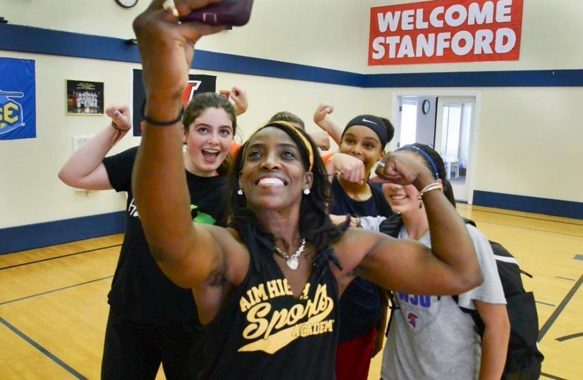 Former Sacramento Monarchs star Ruthie Bolton shoots a selfie with several of her young basketball players who she coaches following a practice session on June 12 in Orangevale.