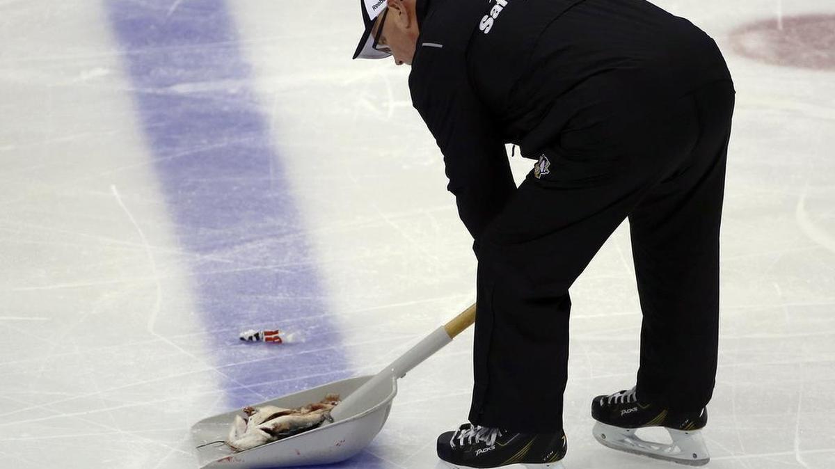 An ice worker removed a fish during the second period in Game 1 of the Stanley Cup Final between the Pittsburgh Penguins and the Nashville Predators on Monday in Pittsburgh.