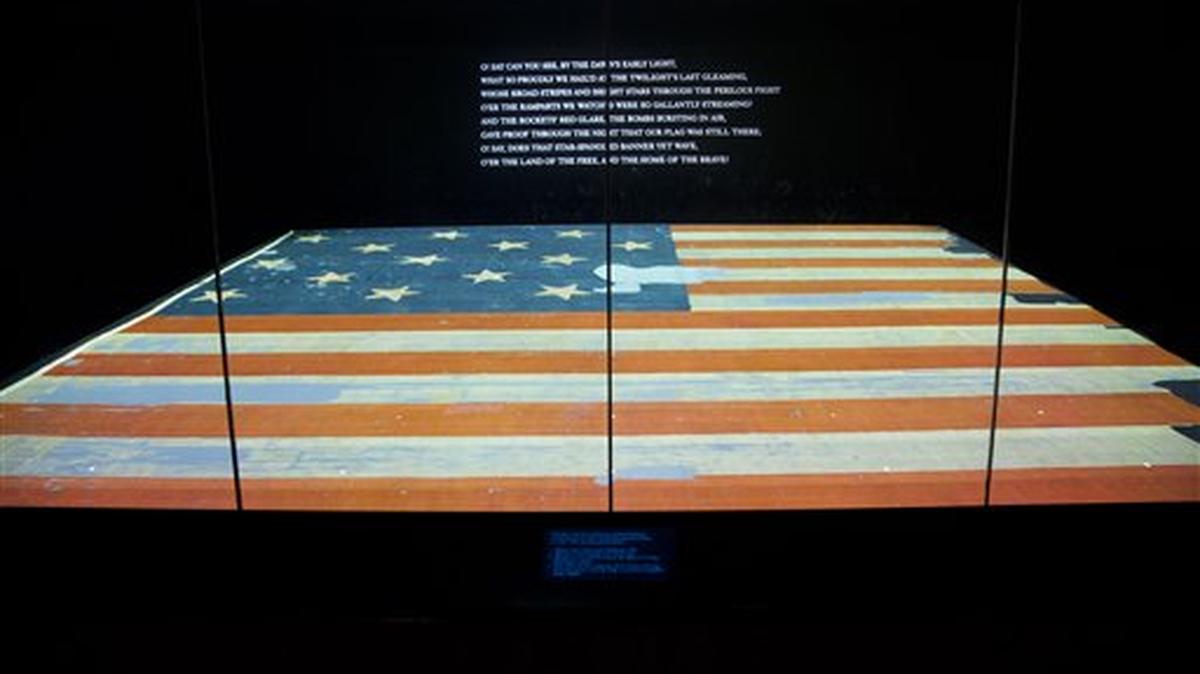 This photo taken Sept. 5, 2014 shows the Smithsonian’s National Museum of American History in Washington exhibit of the flag that inspired the national anthem ‘Star-Spangled Banner’. Years ago parts of the flag were snipped off and handed out as mementos and the Smithsonian has been reacquiring some of those fragments and adding to their collection.