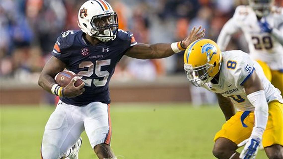 Auburn running back Peyton Barber (25) runs the ball after attempting a stiff arm at San Jose State cornerback Jimmy Pruitt (8) during the second half of an NCAA college football game, Saturday, Oct. 3, 2015, in Auburn, Ala. Auburn won 35-21.