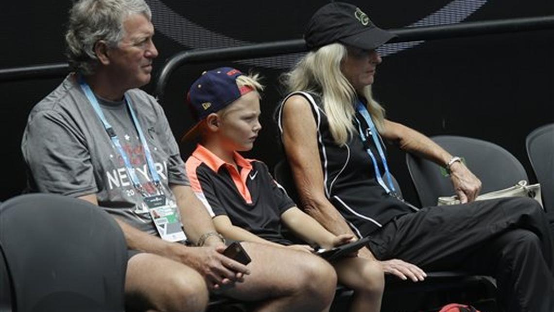 Parents of Australia’s Lleyton Hewitt, father Glynn and mother Cherilyn sit with his son Cruz as they watch him practice on Rod Laver Arena ahead of the Australian Open tennis championships in Melbourne, Australia, Friday, Jan. 15, 2016.