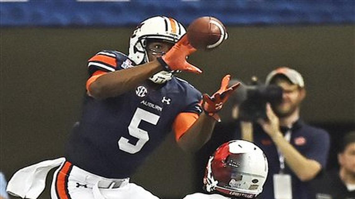 CORRECTS TO CORNERBACK TRUMAINE WASHINGTON (15) FROM WIDE RECEIVER TRAVEON SAMUEL (15) - Auburn wide receiver Ricardo Louis (5) makes a touchdown catch against Louisville cornerback Trumaine Washington (15) during the second half of an NCAA college football game, Saturday, Sept. 5, 2015, in Atlanta. Auburn won 31-24.