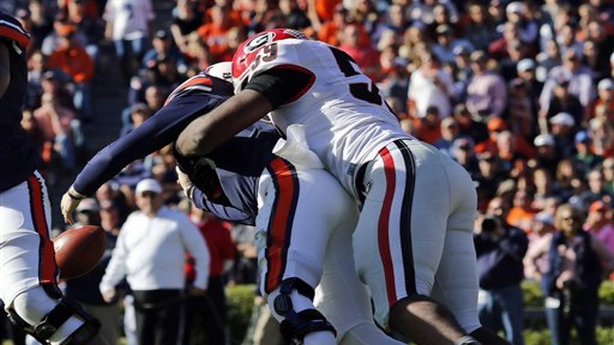 Auburn quarterback Sean White, left, is hit by Georgia's Jordan Jenkins during the second half of an NCAA college football game on Saturday, Nov. 14, 2015 in Auburn, Ala. Georgia won 20-13. (Todd J. Van Emst/Opelika-Auburn News via AP) MANDATORY CREDIT