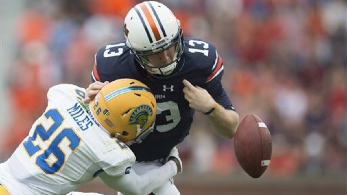 San Jose State safety Vincente Miles, Jr. (26) forces Auburn quarterback Sean White (13) to fumble while tackling him during their NCAA college football game at Jordan-Hare Stadium in Auburn, Ala., on Saturday, Oct. 3, 2015.