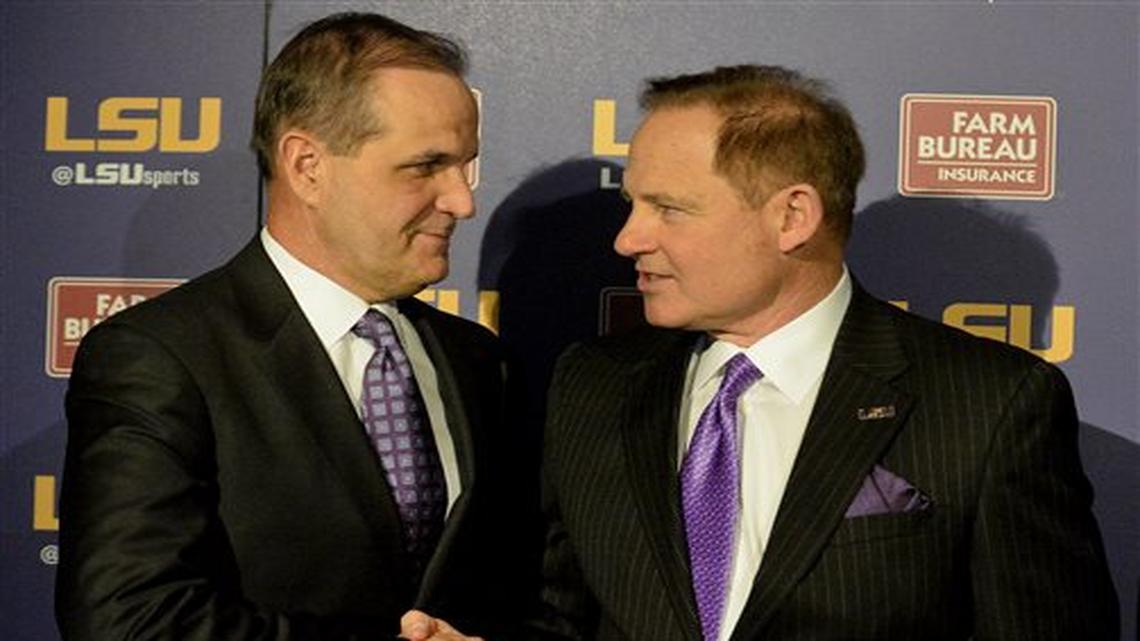 FILE - In this Jan. 14, 2015, file photo, LSU defensive coordinator Kevin Steele, left, shakes hands with LSU head coach Les Miles during a news conference in Baton Rouge, La. After Steele's difficult final year as defensive coordinator at Clemson, it wasn't long before he was back on another staff with Nick Saban at Alabama. So Saban counts himself among the least surprised to see Steele and his new defense thriving at LSU in advance of their matchup with the Crimson Tide.